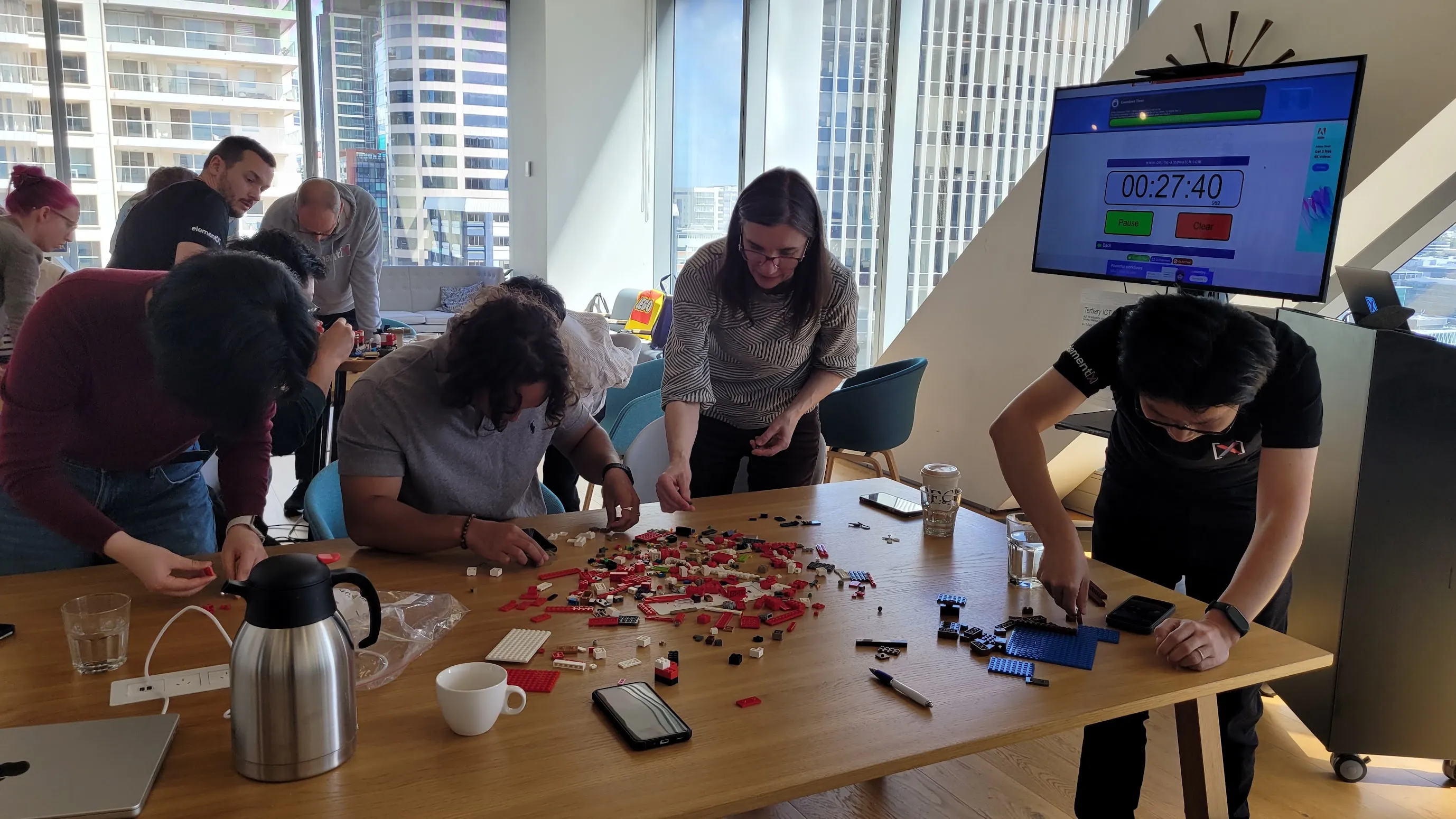 The ElementX team around a table mid-way through a timed Lego build at the Auckland office