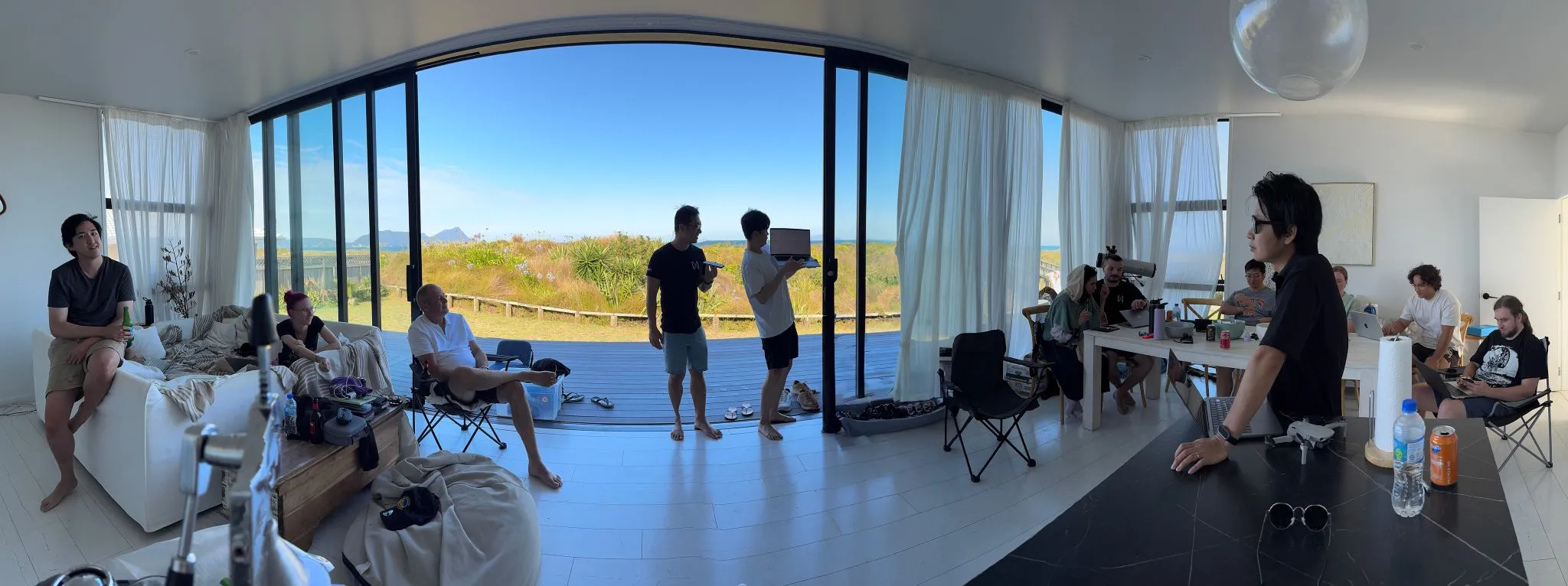 The team gathered around the living room of a beach house for hackathon demos